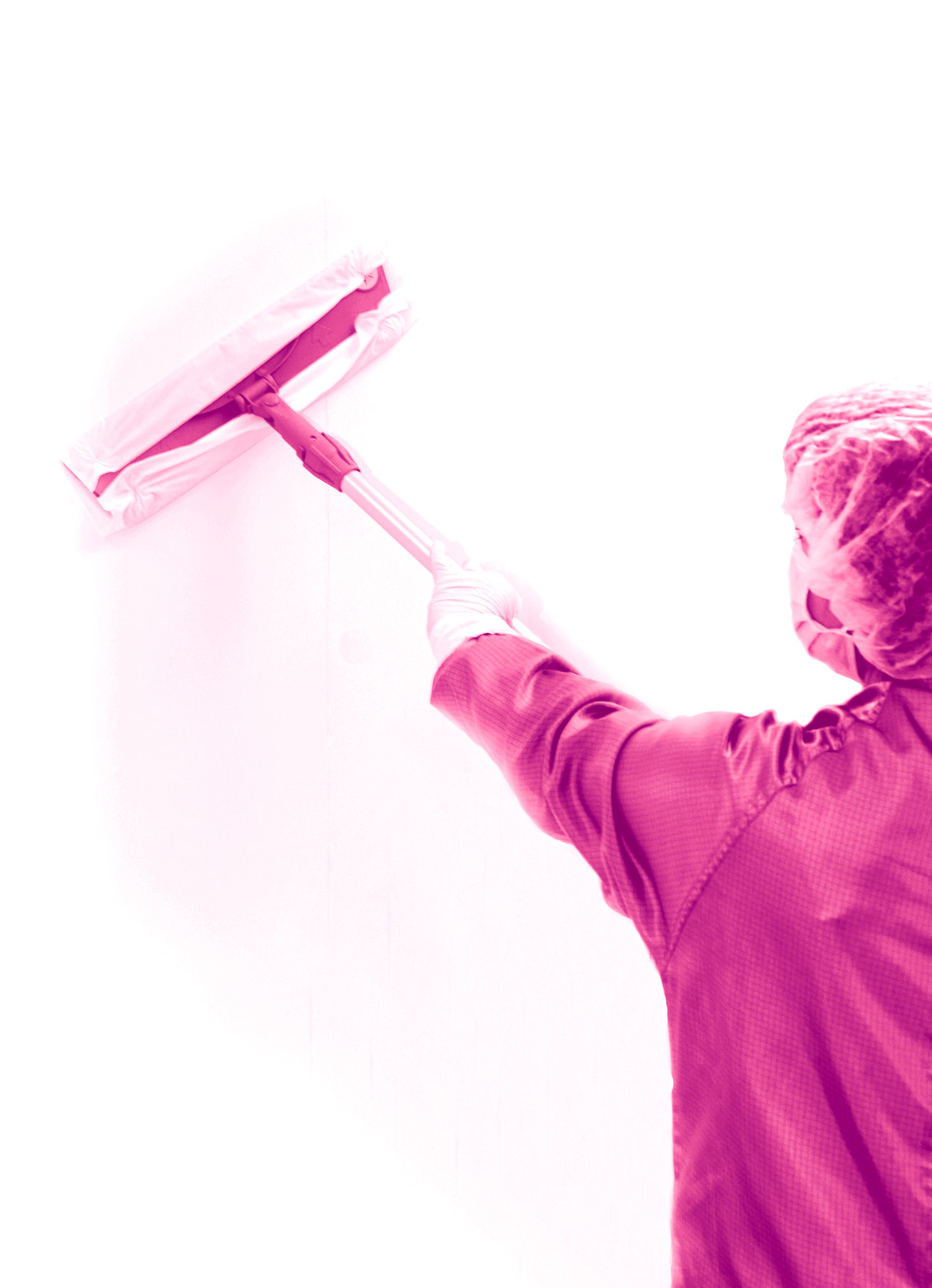 A person in cleanroom apparel using a STAXS® mop to clean a walll A person in cleanroom apparel using a STAXS® mop to clean a walll
